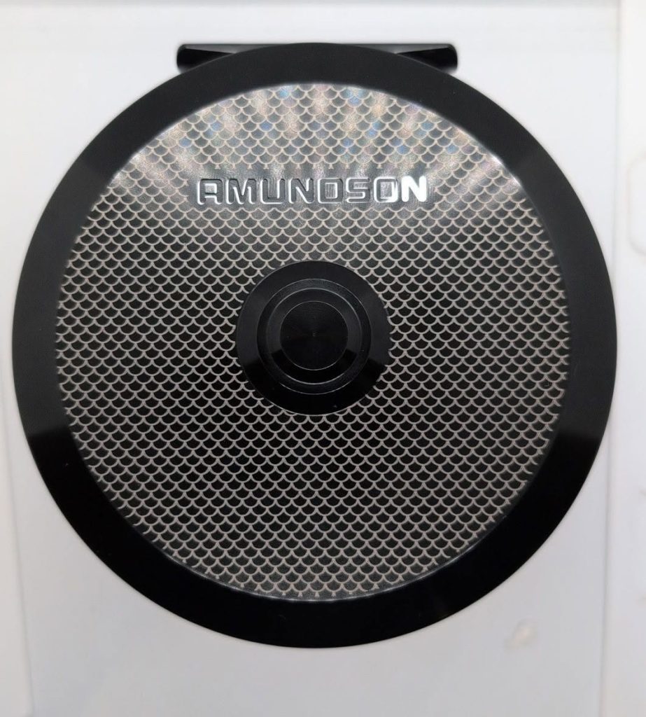 Custom fish scale engraving on an anodized aluminum fishing reel with existing brand name left visible.