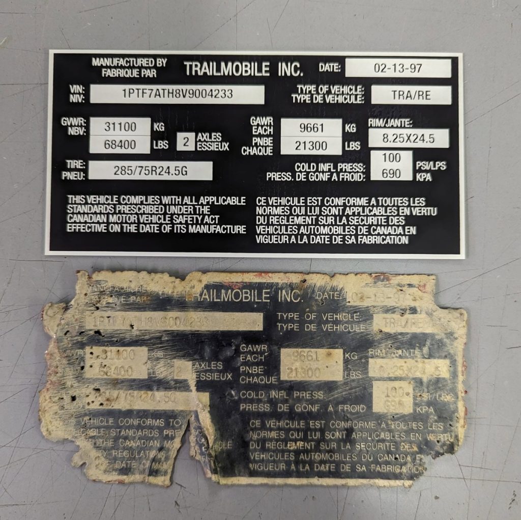 Laser engraved replacement trailer identification plate shown beside the damaged original plate.
